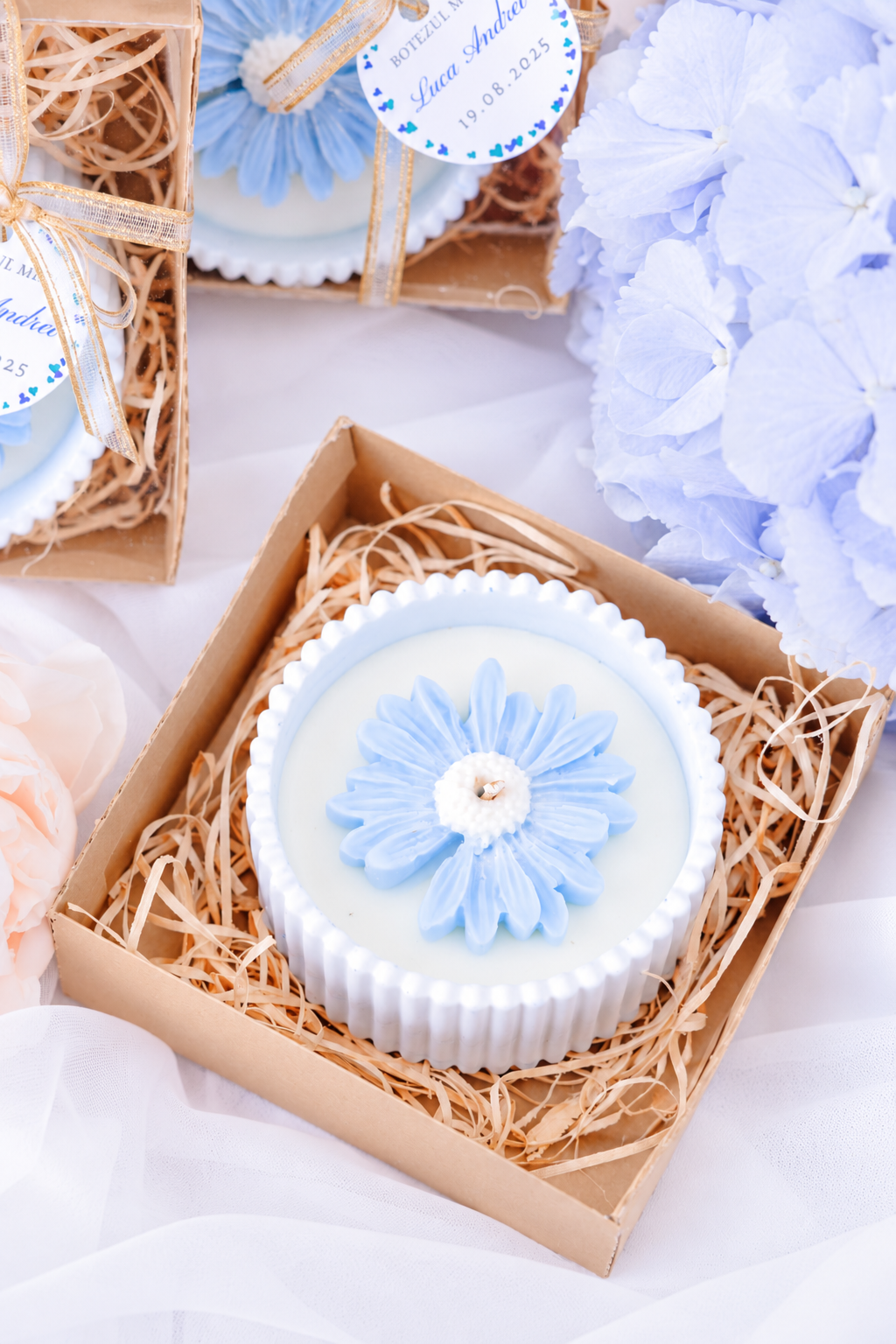 Lumanare cu margareta bleu pentru botez, prezentata in cutie kraft cu ambalaj personalizat